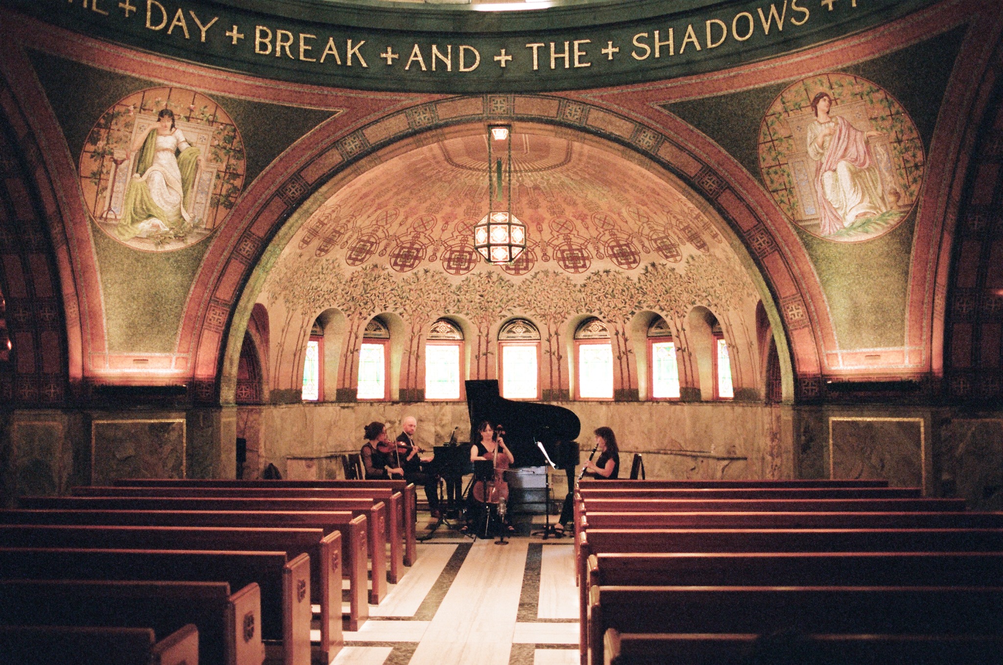 Wide symmetrical view of the quartet performing beneath the chapel mosaic