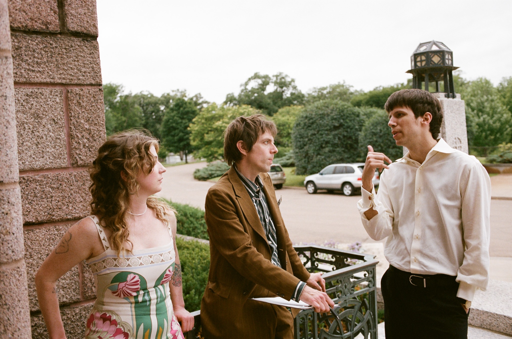 Three event participants talking outside the chapel