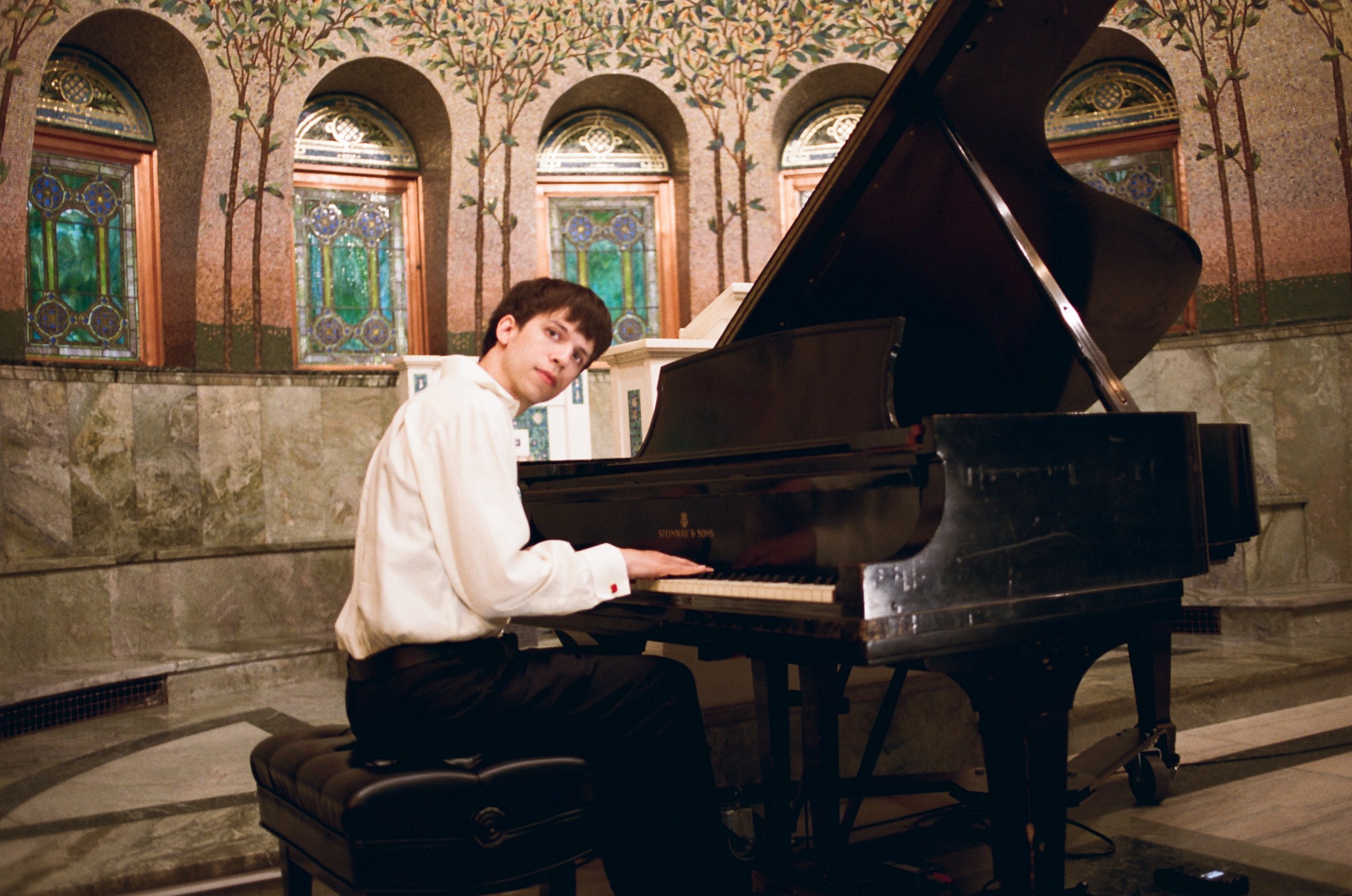 Pianist at the grand piano inside the chapel